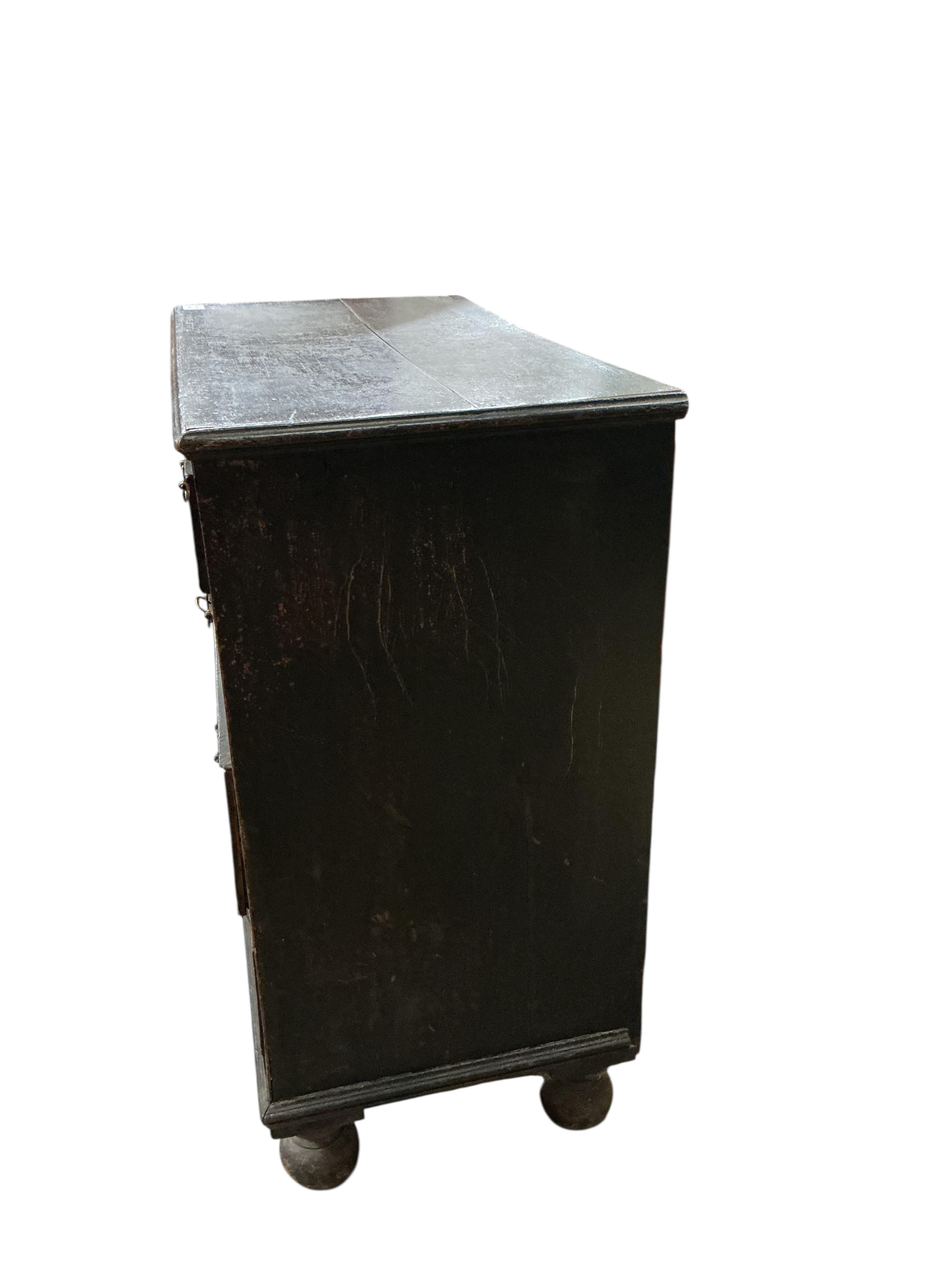 An 18th century oak chest, fitted with two short and three long drawers, later carved, width 89cm, depth 46cm, height 96cm